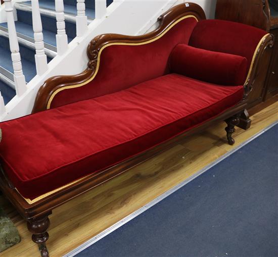 A Victorian mahogany chaise longue covered in red velvet, W.180cm